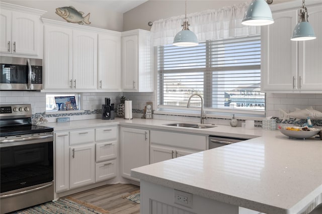 1286 Lagoon Dr, Crystal Beach, TX 77650 - kitchen with stainless steel appliances, a sink, white cabinets, and backsplash