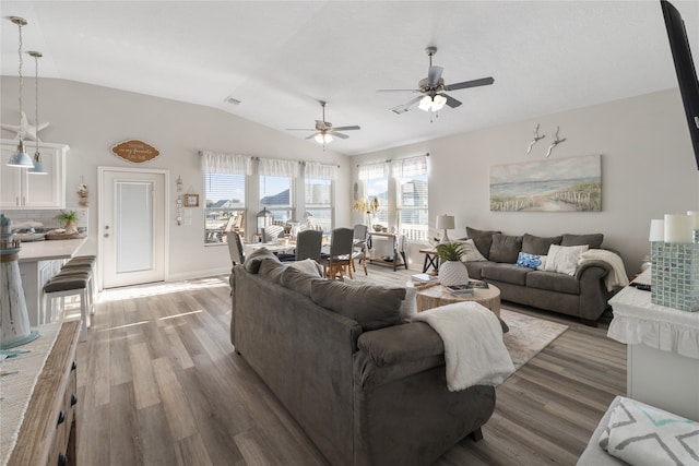 living room featuring vaulted ceiling, ceiling fan, and wood-type flooring