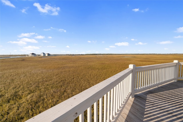 wooden terrace featuring a rural view