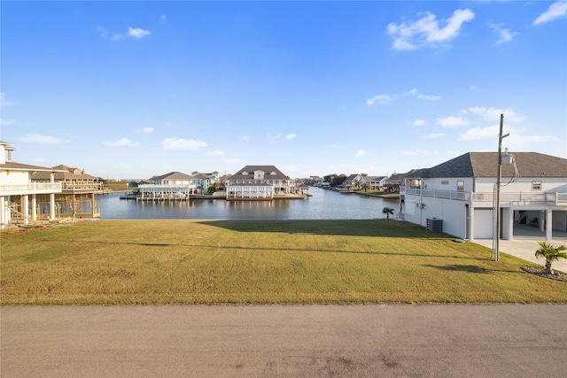 dock area with central air condition unit, a lawn, and a water view