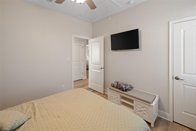 1286 Lagoon Dr, Crystal Beach, TX 77650 - bedroom featuring attic access, light wood-style floors, baseboards, and ceiling fan