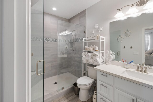 1286 Lagoon Dr, Crystal Beach, TX 77650 - ensuite bathroom with a shower stall, toilet, vanity, and wood finished floors
