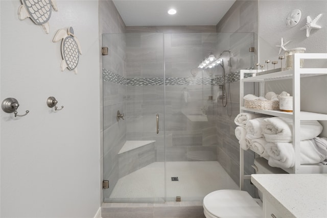 bathroom with vanity, toilet, and an enclosed shower