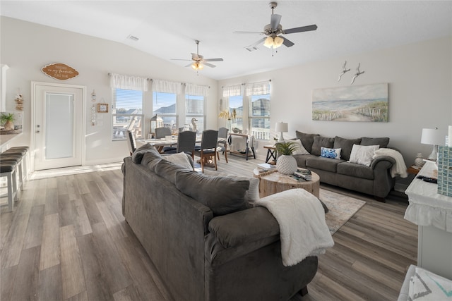 living room with light wood-type flooring, lofted ceiling, and ceiling fan