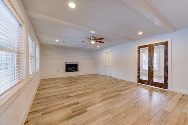 unfurnished living room featuring beam ceiling, french doors, ceiling fan, and light hardwood / wood-style flooring