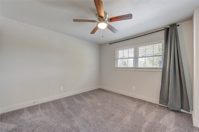 spare room featuring ceiling fan and carpet