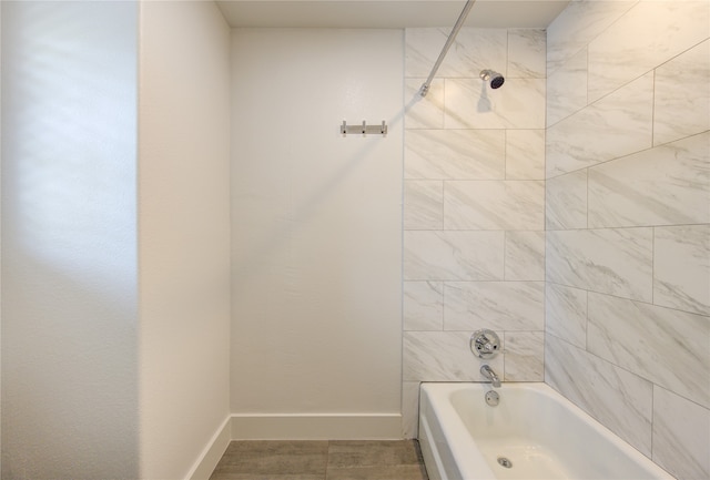 bathroom with tile patterned flooring and tiled shower / bath combo