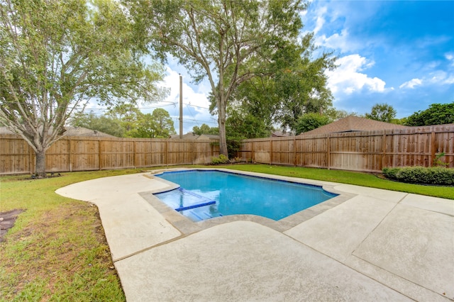 view of pool with a lawn and a patio area