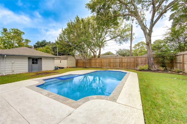 view of pool with a patio area, a yard, and a storage unit