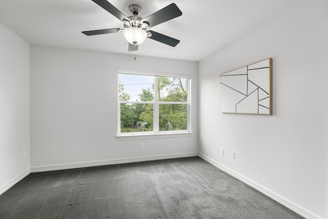 spare room with ceiling fan and carpet