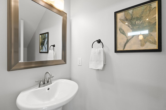 bathroom with lofted ceiling and sink