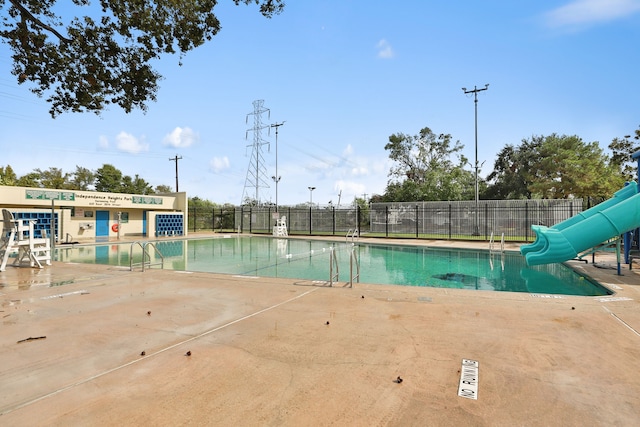 view of swimming pool with a water slide