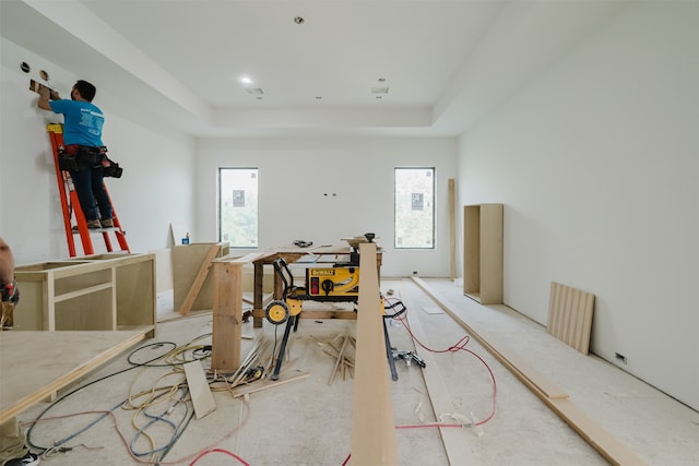 interior space featuring a workshop area and a raised ceiling