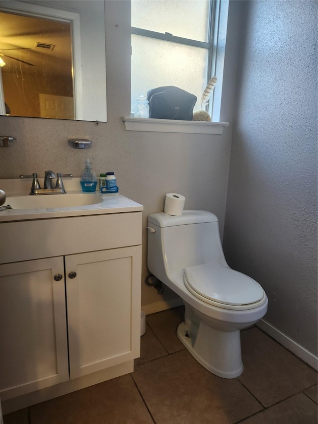 bathroom featuring vanity, toilet, and tile patterned flooring