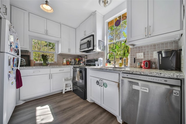 kitchen with stainless steel appliances, dark wood-type flooring, white cabinets, sink, and backsplash