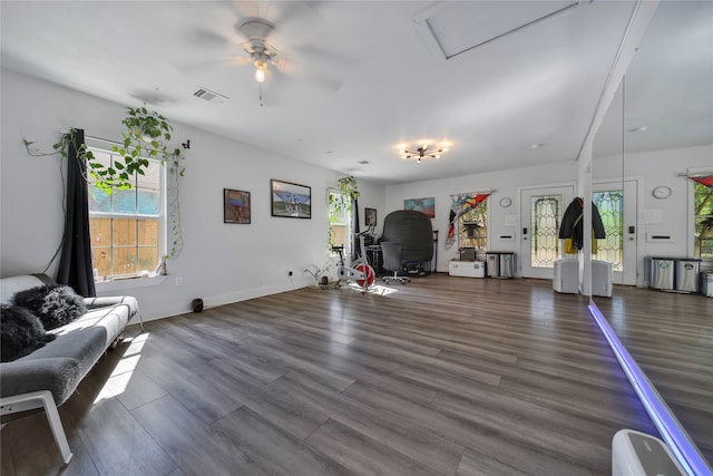 living room with dark hardwood / wood-style flooring and ceiling fan