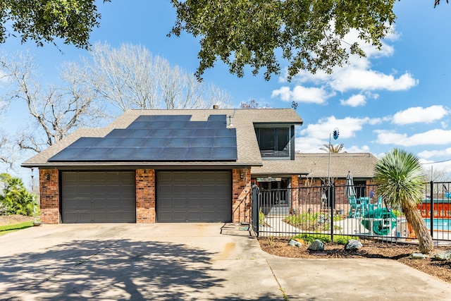 view of front facade featuring solar panels