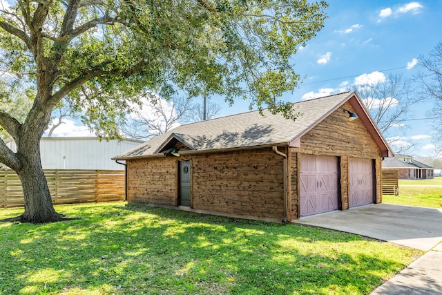 view of front of property with a front yard, a garage, and an outdoor structure