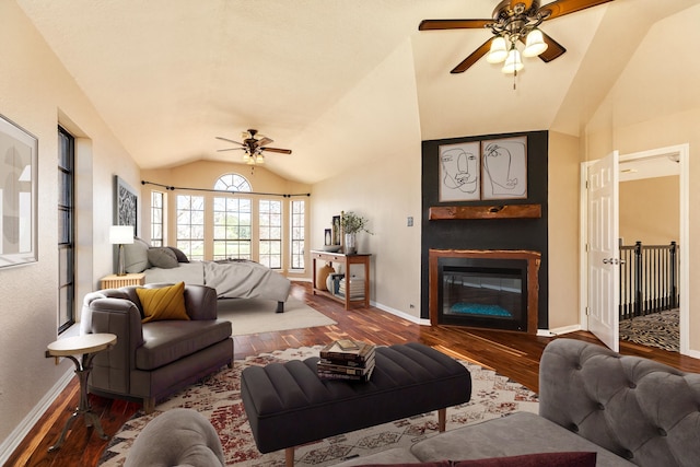 living room with ceiling fan, lofted ceiling, and hardwood / wood-style flooring