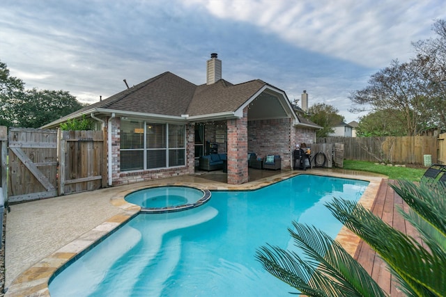 view of pool with an in ground hot tub and a patio area