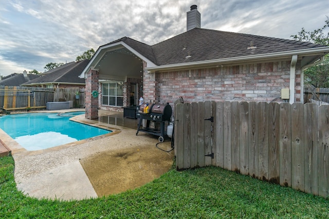 view of swimming pool with a grill and a patio