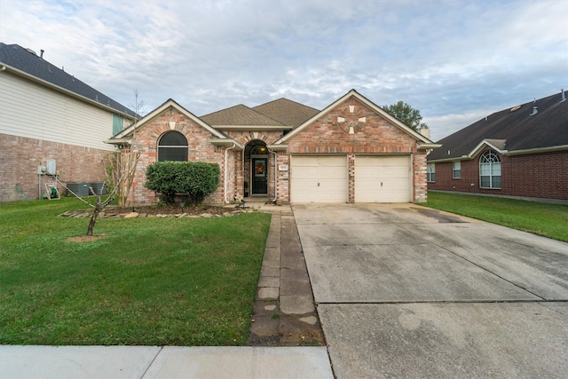 single story home with a garage and a front lawn