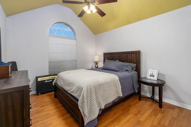 bedroom with light hardwood / wood-style floors, ceiling fan, and vaulted ceiling