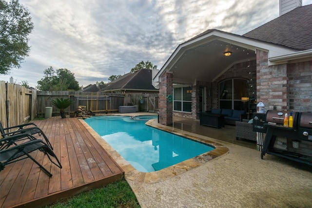 view of swimming pool featuring a deck and a patio