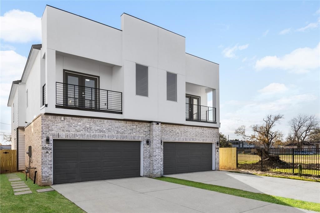 view of front of home featuring a garage and a balcony