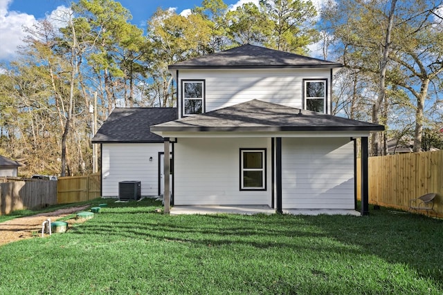 back of property featuring a yard, a patio, and central AC