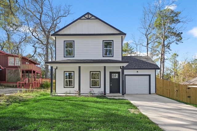 view of front of property featuring a porch, a front yard, and a garage