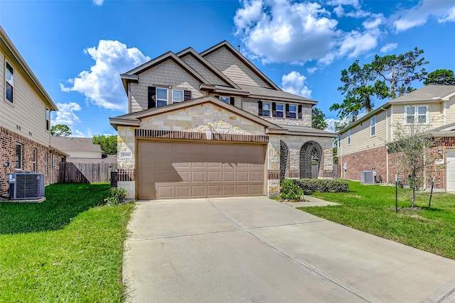 view of front of house featuring a garage, cooling unit, and a front lawn