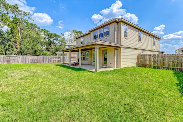 rear view of property with a lawn and a patio