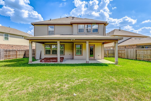 rear view of house with a lawn and a patio area