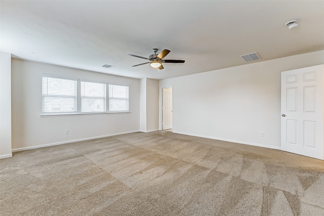 carpeted empty room featuring ceiling fan