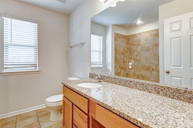 bathroom with tile patterned flooring, vanity, and toilet