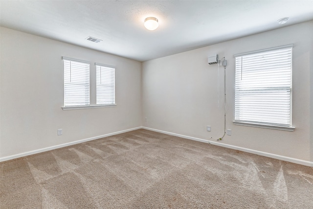 spare room with a healthy amount of sunlight and carpet floors