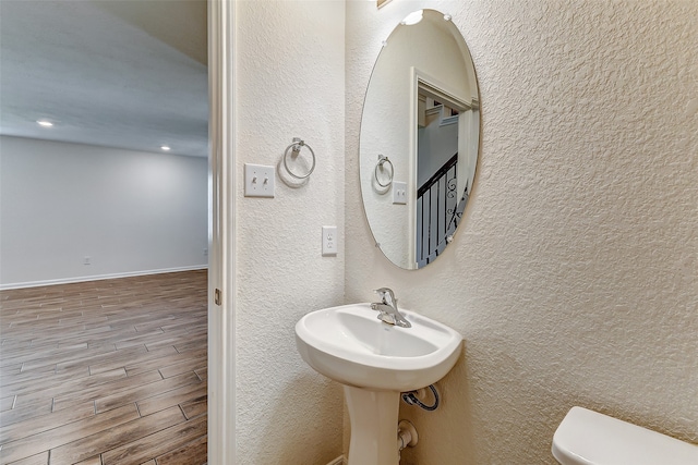 bathroom featuring toilet and hardwood / wood-style flooring