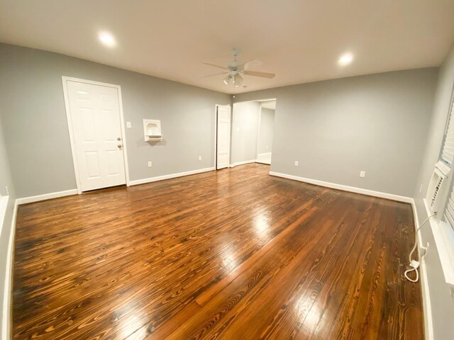 empty room featuring ceiling fan and dark hardwood / wood-style floors