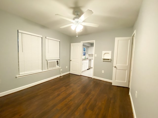 unfurnished bedroom with dark wood-type flooring, cooling unit, and ceiling fan