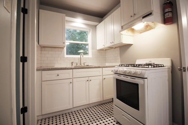 kitchen with white cabinets, sink, white range with gas cooktop, and backsplash