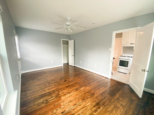 spare room with ceiling fan and dark hardwood / wood-style flooring