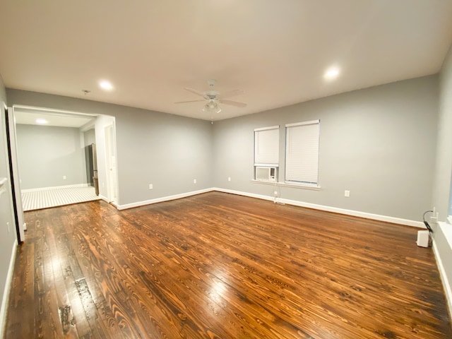 unfurnished room featuring ceiling fan and dark hardwood / wood-style floors