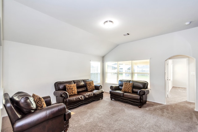 carpeted living room featuring lofted ceiling