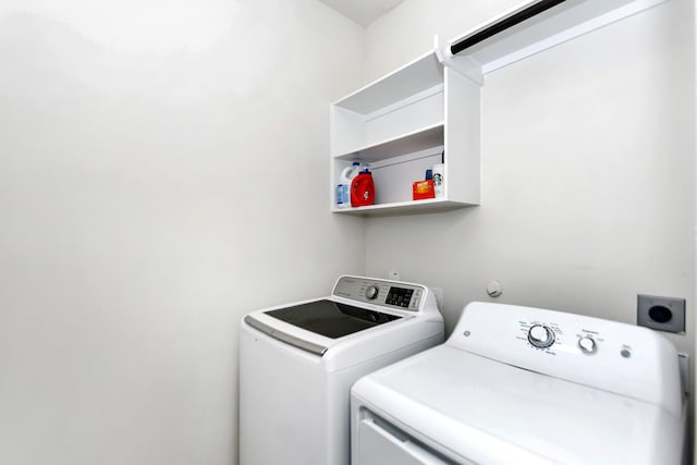 laundry area with washing machine and clothes dryer