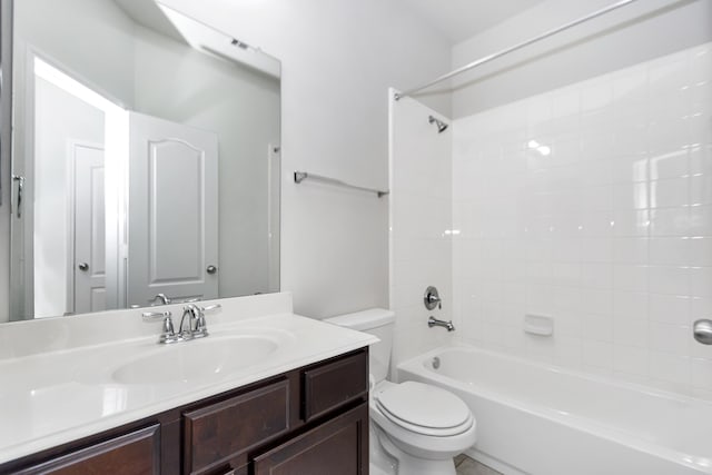 full bathroom with vanity, tiled shower / bath combo, and toilet