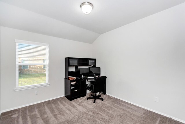 home office with light colored carpet and vaulted ceiling