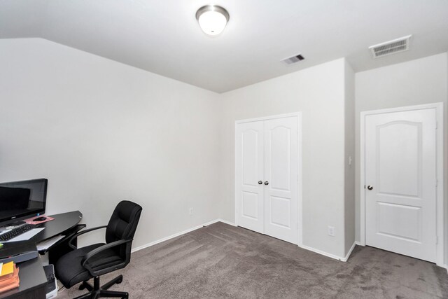 carpeted office space featuring vaulted ceiling