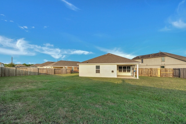 rear view of house featuring a lawn