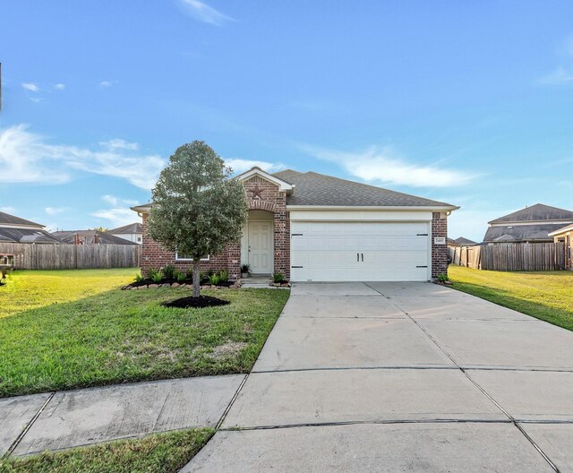 view of front of house featuring a front lawn and a garage